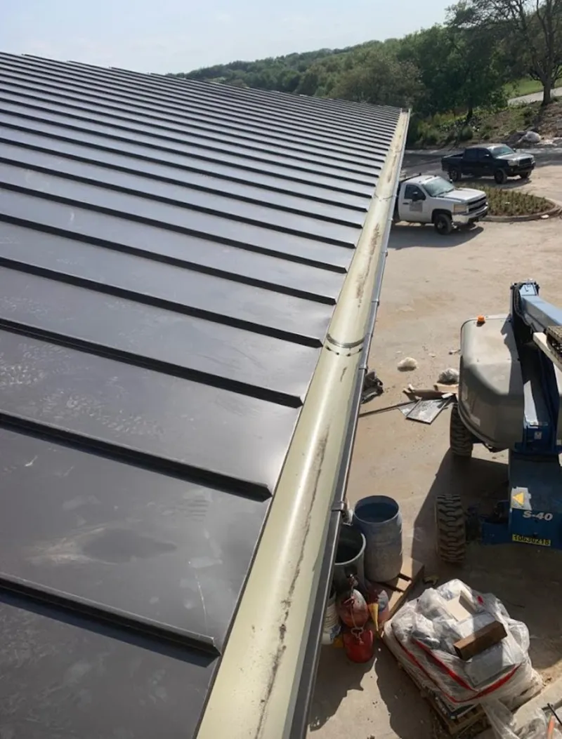 Standing seam panel and gutter detail on a metal roofing jobsite in Ramsey